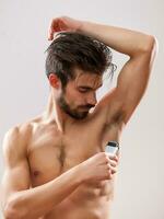 A man shaving his armpit photo