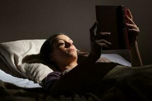 A woman reading on a tablet photo