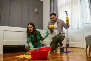 A young couple cleaning together photo