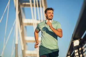 A man in a green t-shirt running photo