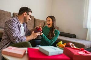 Young couple is exchanging gifts photo