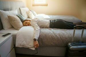 A tired businesswoman in her room after returning from a trip photo