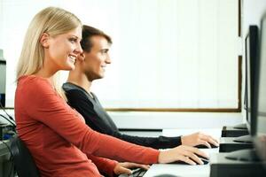 Students learning in a computer lab photo