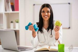 Female doctor working in her office photo