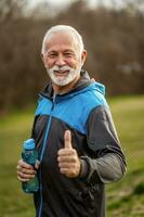 A senior man doing physical exercises photo