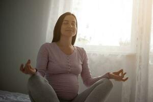 A pregnant woman doing yoga photo