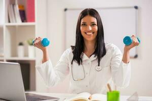 Female doctor working in her office photo