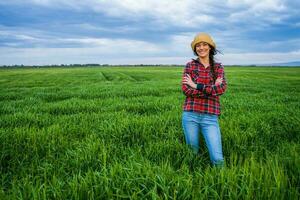 A farmer standing in a barley field photo