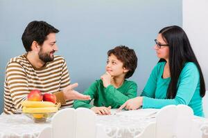 Parents are helping their son with the homework photo