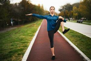 A young woman doing physical exercises photo