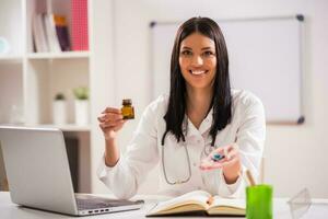 Female doctor working in her office photo