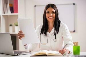 Female doctor working in her office photo