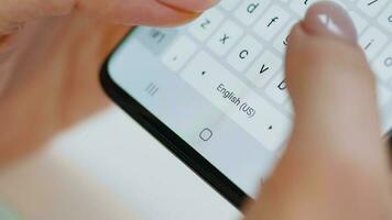 Hands typing text on smartphone close-up video