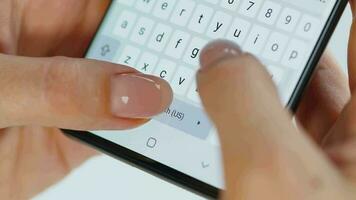 Hands typing text on smartphone close-up video