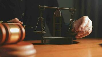 Justice and law concept.Male judge in a courtroom with the gavel, working with, computer and docking keyboard, eyeglasses, on table in morning light video