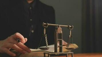 Justice and law concept.Male judge in a courtroom with the gavel, working with, computer and docking keyboard, eyeglasses, on table in morning light video