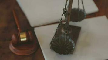 Justice and law concept.Male judge in a courtroom with the gavel, working with, computer and docking keyboard, eyeglasses, on table in morning light video