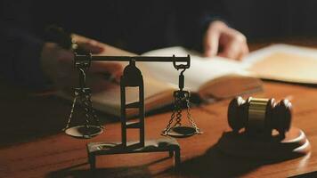 Justice and law concept.Male judge in a courtroom with the gavel, working with, computer and docking keyboard, eyeglasses, on table in morning light video