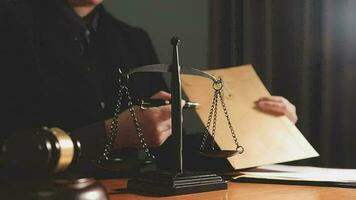 Justice and law concept.Male judge in a courtroom with the gavel, working with, computer and docking keyboard, eyeglasses, on table in morning light video