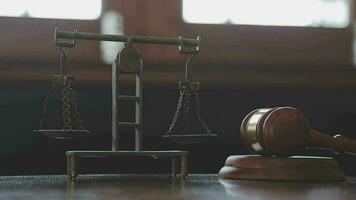 Justice and law concept.Male judge in a courtroom with the gavel, working with, computer and docking keyboard, eyeglasses, on table in morning light video