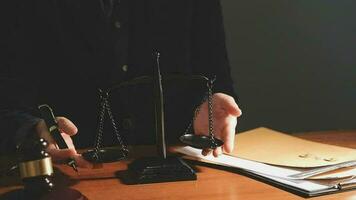 Justice and law concept.Male judge in a courtroom with the gavel, working with, computer and docking keyboard, eyeglasses, on table in morning light video