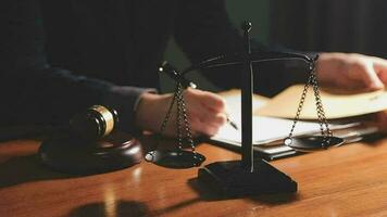 Justice and law concept.Male judge in a courtroom with the gavel, working with, computer and docking keyboard, eyeglasses, on table in morning light video