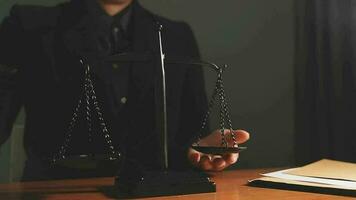 Justice and law concept.Male judge in a courtroom with the gavel, working with, computer and docking keyboard, eyeglasses, on table in morning light video