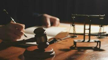 Justice and law concept.Male judge in a courtroom with the gavel, working with, computer and docking keyboard, eyeglasses, on table in morning light video