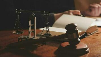 Justice and law concept.Male judge in a courtroom with the gavel, working with, computer and docking keyboard, eyeglasses, on table in morning light video