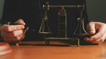 Justice and law concept.Male judge in a courtroom with the gavel, working with, computer and docking keyboard, eyeglasses, on table in morning light video