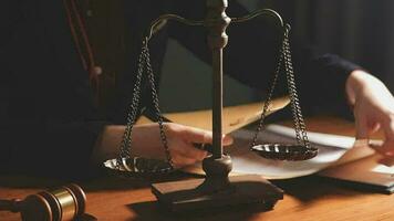 Justice and law concept.Male judge in a courtroom with the gavel, working with, computer and docking keyboard, eyeglasses, on table in morning light video