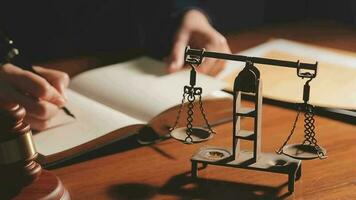 Justice and law concept.Male judge in a courtroom with the gavel, working with, computer and docking keyboard, eyeglasses, on table in morning light video