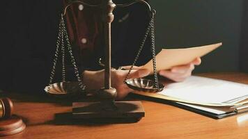 Justice and law concept.Male judge in a courtroom with the gavel, working with, computer and docking keyboard, eyeglasses, on table in morning light video