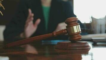 Justice and law concept.Male judge in a courtroom with the gavel, working with, computer and docking keyboard, eyeglasses, on table in morning light video