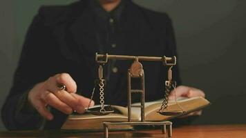 Justice and law concept.Male judge in a courtroom with the gavel, working with, computer and docking keyboard, eyeglasses, on table in morning light video