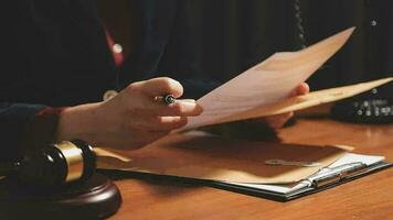 Justice and law concept.Male judge in a courtroom with the gavel, working with, computer and docking keyboard, eyeglasses, on table in morning light video