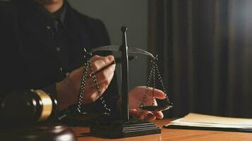 Justice and law concept.Male judge in a courtroom with the gavel, working with, computer and docking keyboard, eyeglasses, on table in morning light video