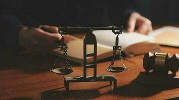 Justice and law concept.Male judge in a courtroom with the gavel, working with, computer and docking keyboard, eyeglasses, on table in morning light video