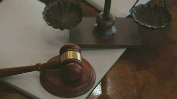 Justice and law concept.Male judge in a courtroom with the gavel, working with, computer and docking keyboard, eyeglasses, on table in morning light video