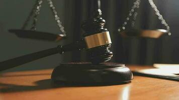 Justice and law concept.Male judge in a courtroom with the gavel, working with, computer and docking keyboard, eyeglasses, on table in morning light video