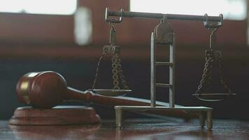 Justice and law concept.Male judge in a courtroom with the gavel, working with, computer and docking keyboard, eyeglasses, on table in morning light video