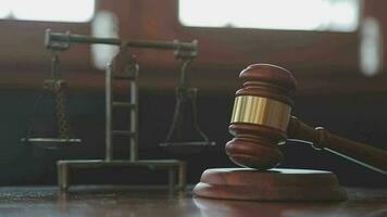 Justice and law concept.Male judge in a courtroom with the gavel, working with, computer and docking keyboard, eyeglasses, on table in morning light video