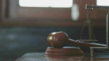 Justice and law concept.Male judge in a courtroom with the gavel, working with, computer and docking keyboard, eyeglasses, on table in morning light video