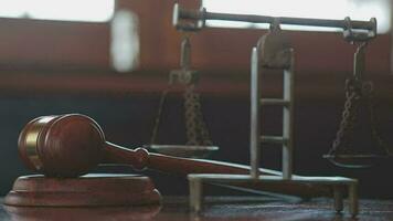 Justice and law concept.Male judge in a courtroom with the gavel, working with, computer and docking keyboard, eyeglasses, on table in morning light video