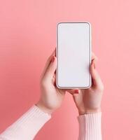 Mobile phone with empty white screen in hand on pink background photo