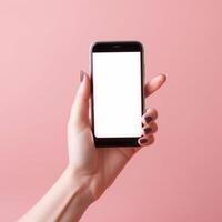 Mobile phone with empty white screen in hand on pink background photo
