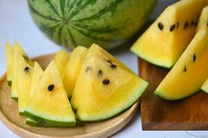 Sweet watermelon slices pieces fresh watermelon tropical summer fruit, Yellow watermelon slice on plate photo