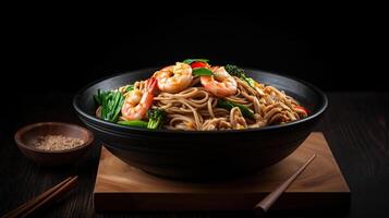 Stir fry noodles with vegetables and beef in black bowl, photo