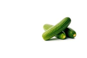 A pile of fresh green cucumbers isolated on white background with copy space. photo