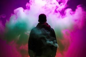 a man standing in front of a cloud of smoke with neon lights. photo